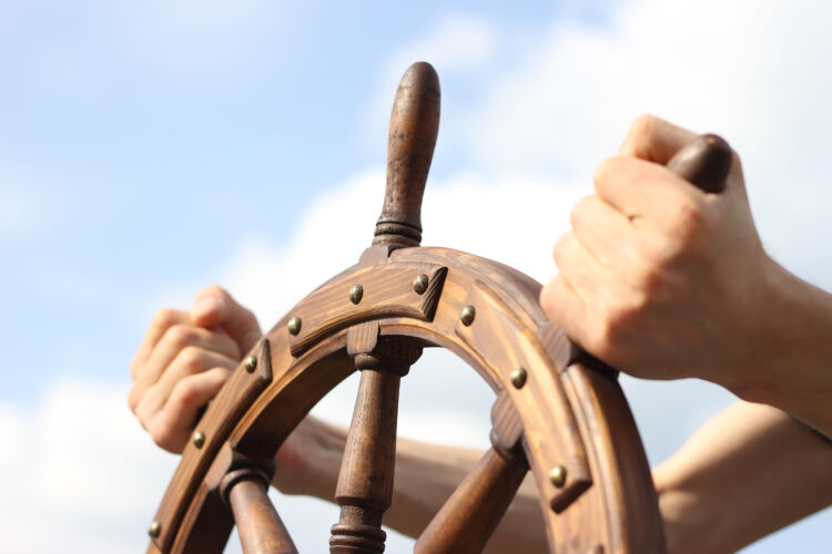 steering,hand,wheel,ship,on,sky,background,,hand,hold,hand